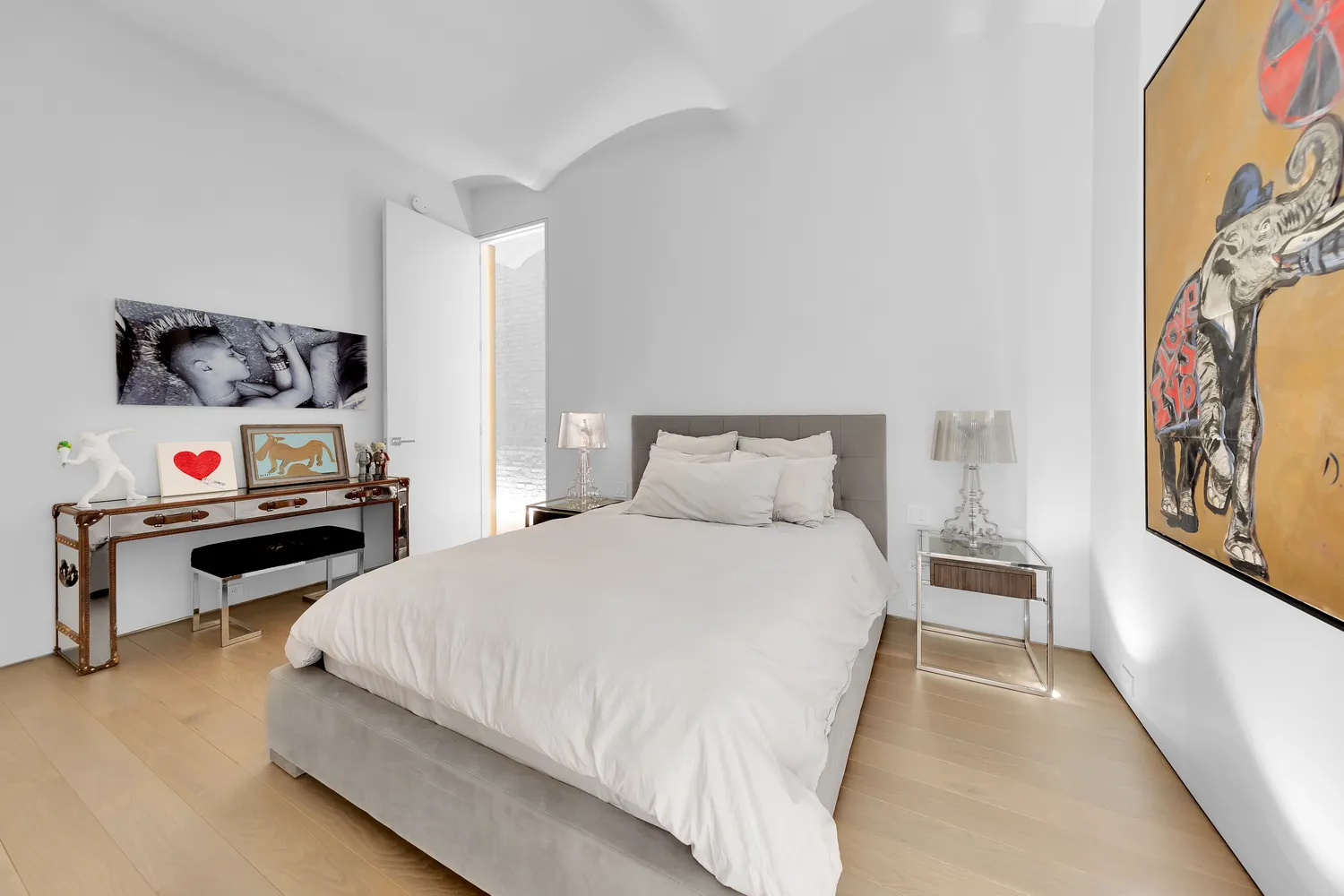 a bedroom with a bed and a white comforter