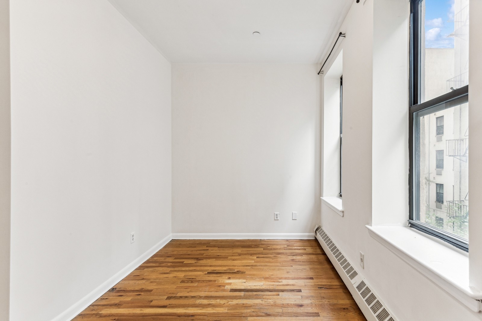 307 West 111th Street, Unit 2R Manhattan, NY 10026 - Photo 3 of 16 a view of a room with wooden floor and a window