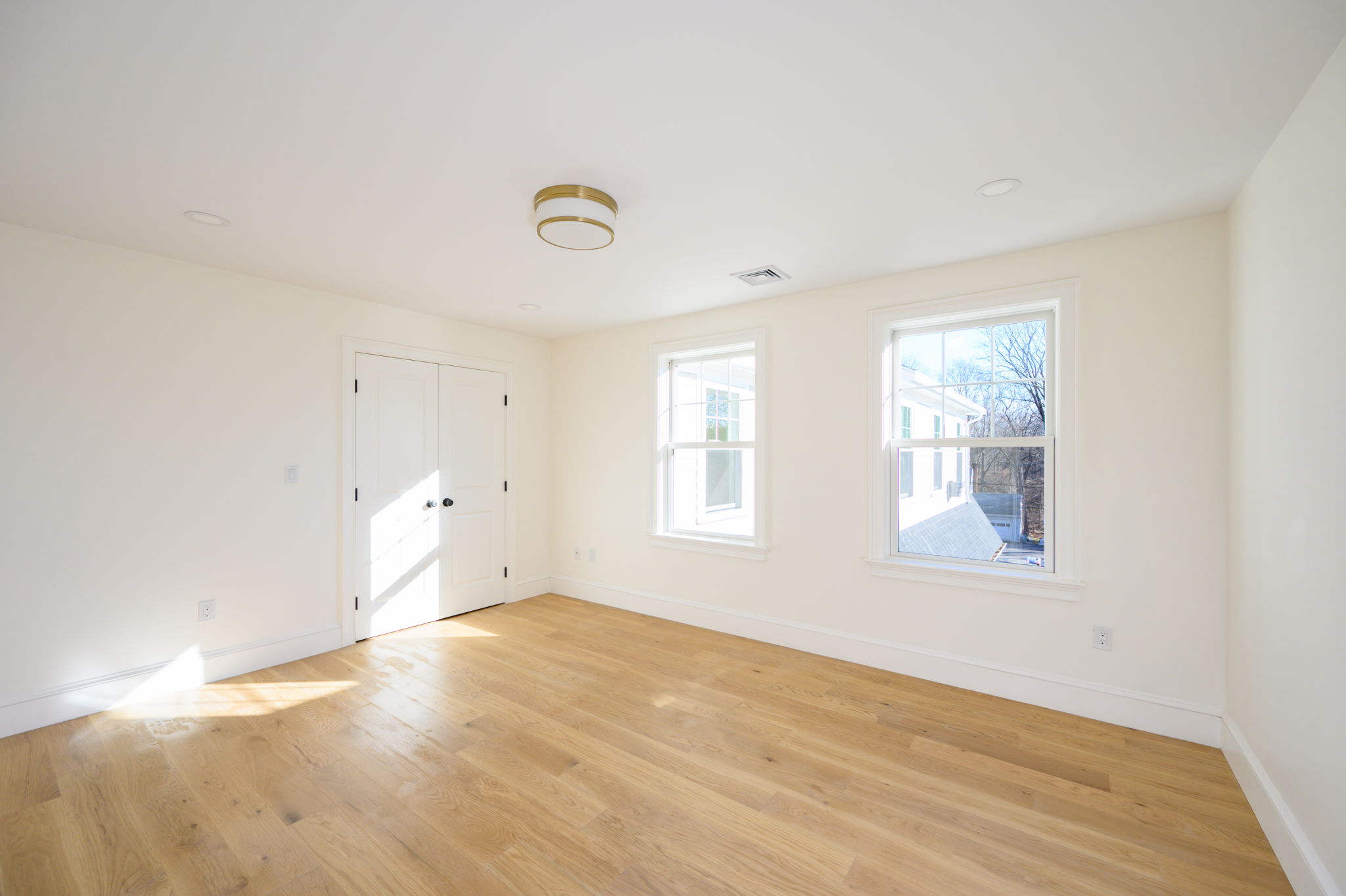 249 Central Avenue Milton, MA 02186 - Photo 36 of 61 an empty room with wooden floor and windows
