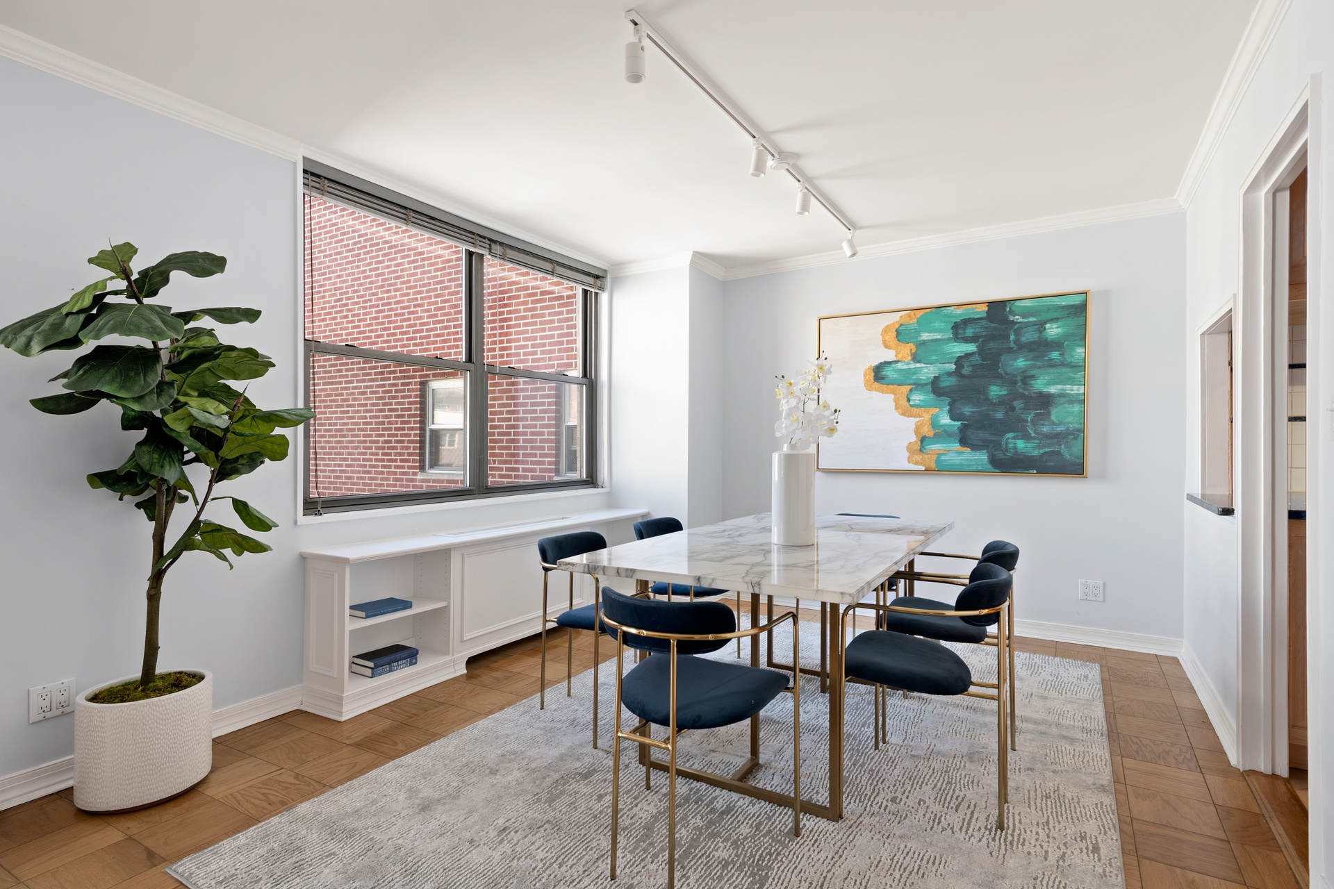 444 East 86th Street, Unit 14G Manhattan, NY 10028 - Photo 2 of 10 a living room with furniture a potted plant and a window