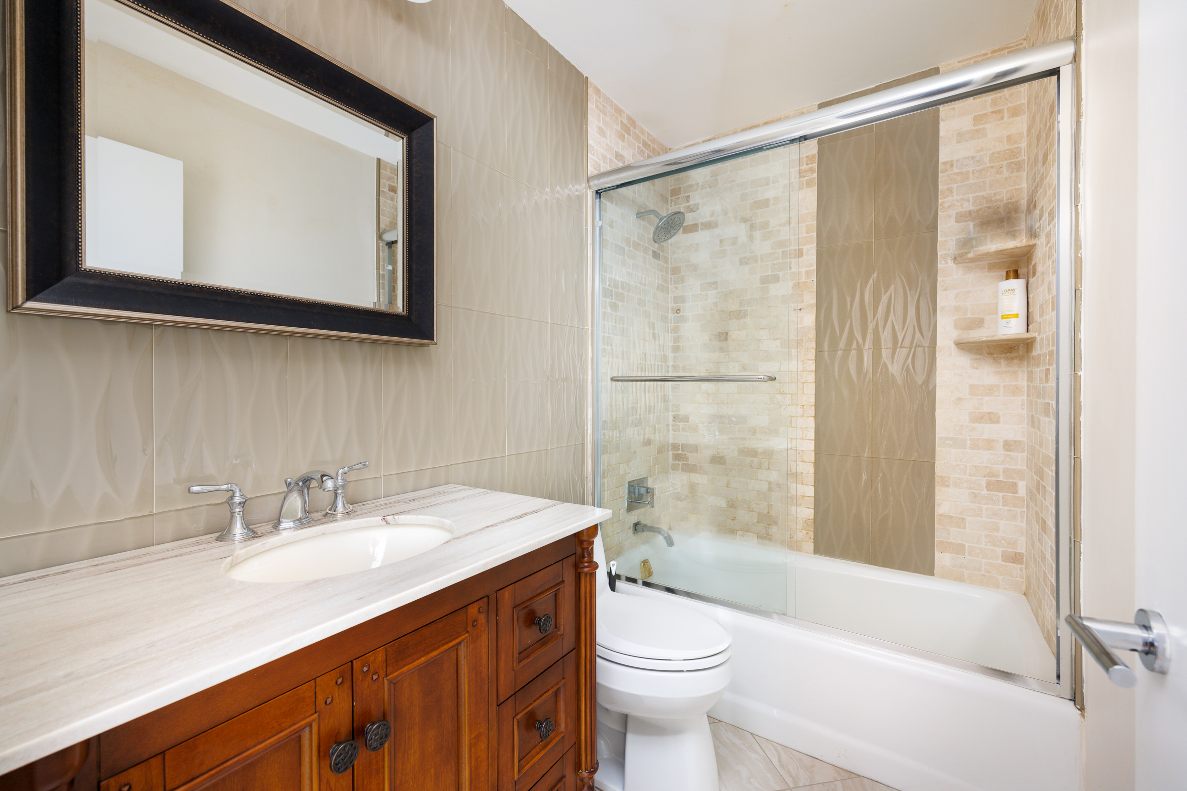 222 West 14th Street, Unit 3N Manhattan, NY 10011 - Photo 5 of 9 a bathroom with a sink a toilet and shower