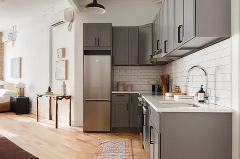 a kitchen with stainless steel appliances a refrigerator sink and cabinets