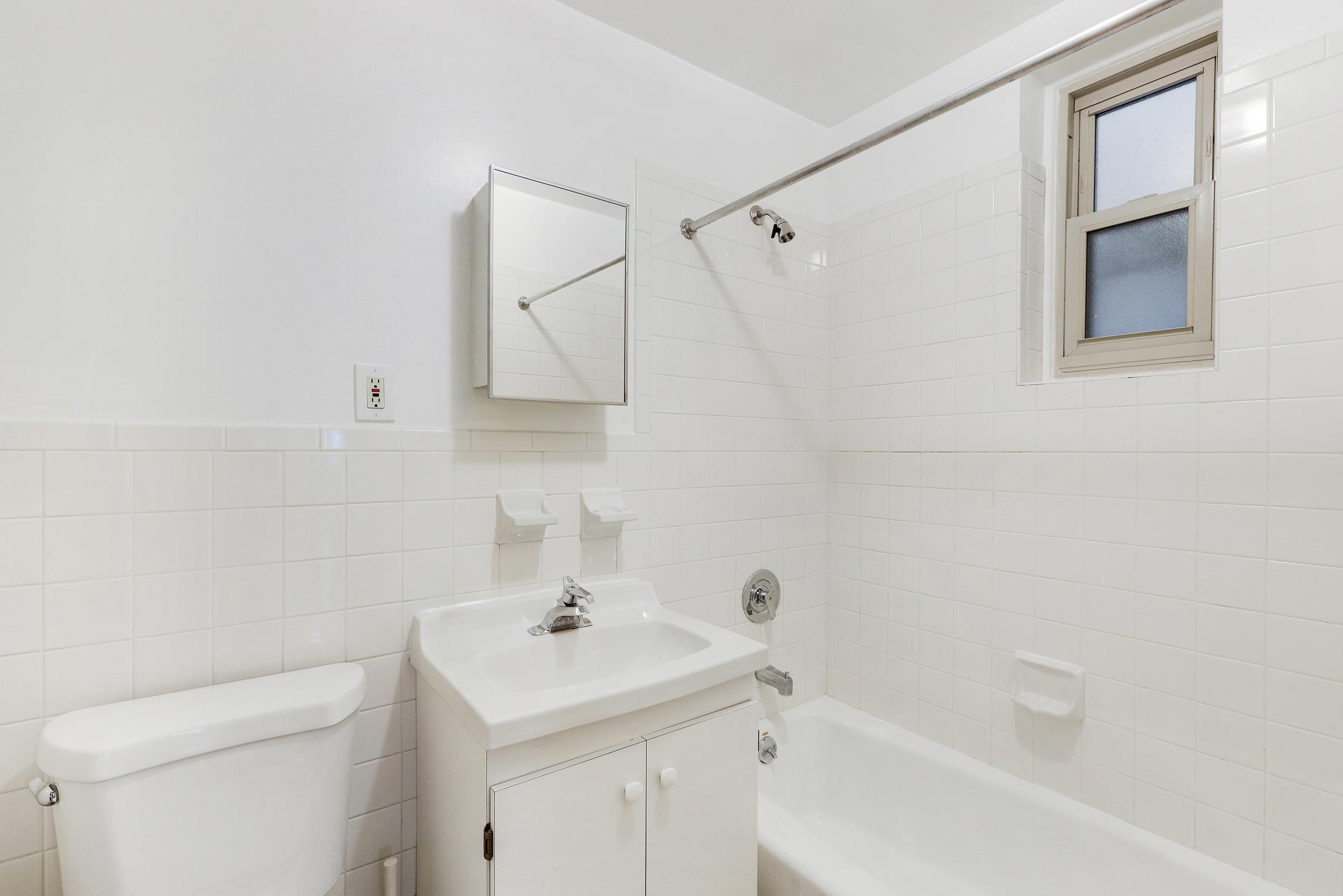323 West 43rd Street, Unit 4R Manhattan, NY 10036 - Photo 10 of 14 a bathroom with a sink a toilet and shower