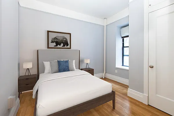 a bedroom with a bed and a window