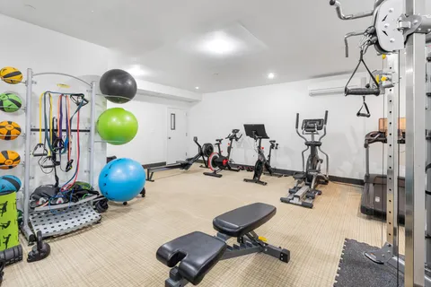 a room with gym equipment and view of living room