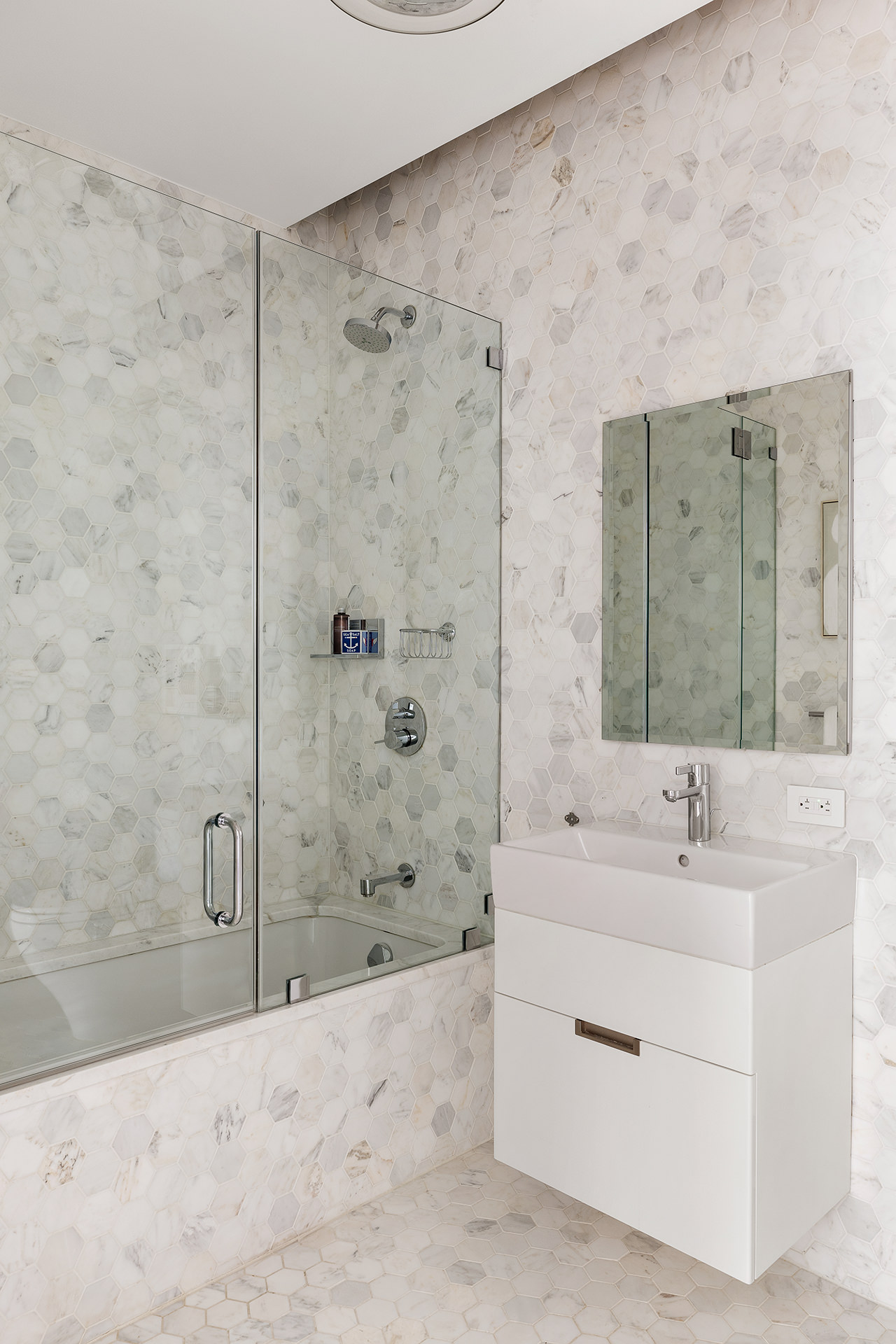 325 West Broadway, Unit 7B Manhattan, NY 10013 - Photo 11 of 21 a bathroom with a sink mirror and a bathtub