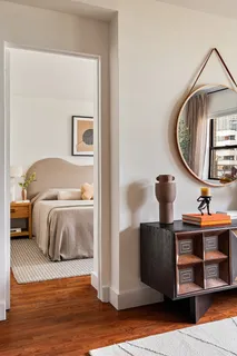 a bedroom with a bed and a mirror