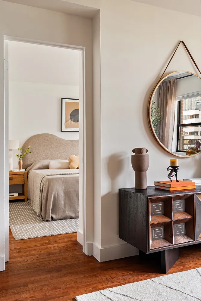 a bedroom with a bed and a mirror