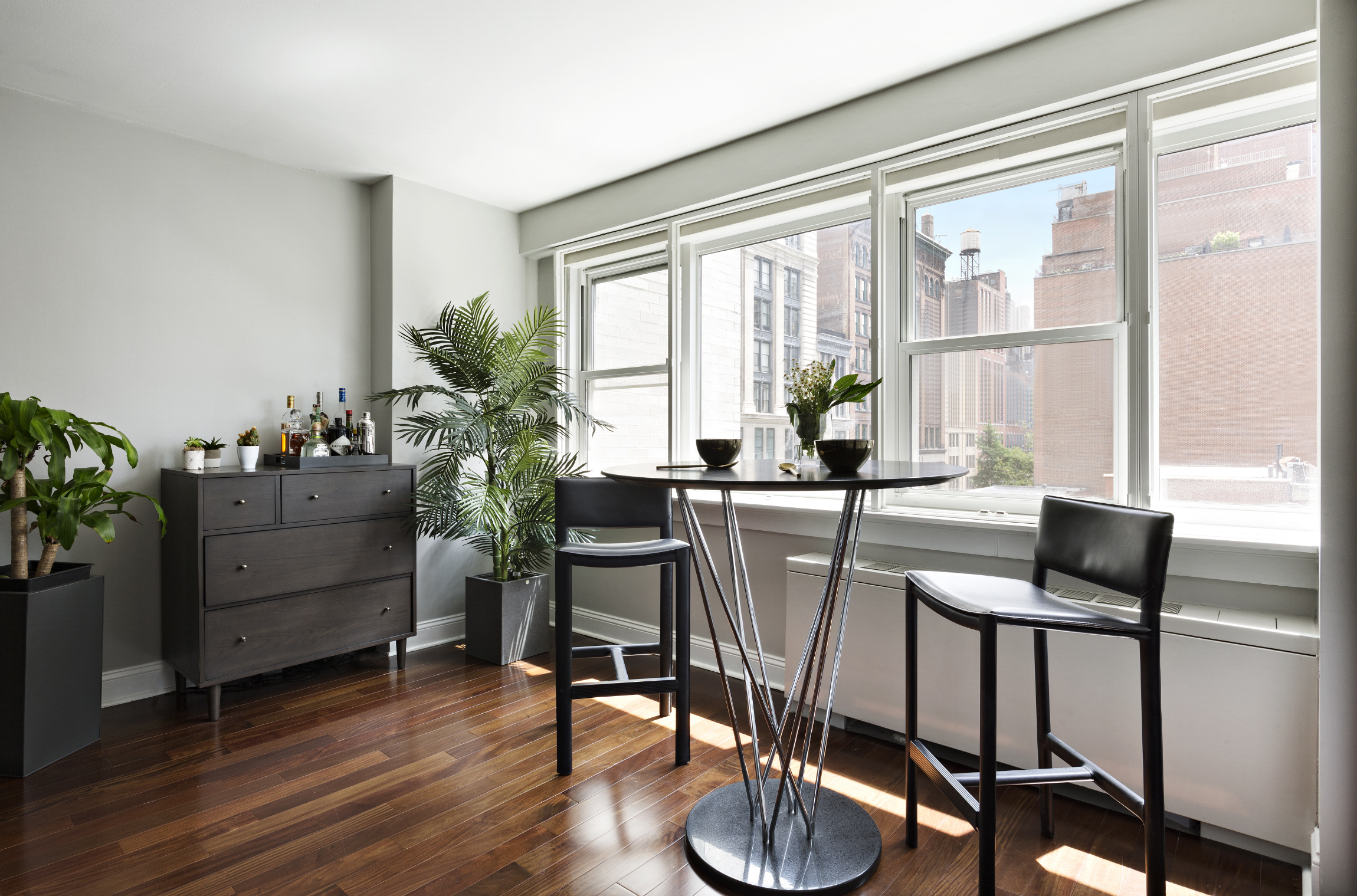 101 West 12th Street, Unit 6L Manhattan, NY 10011 - Photo 2 of 11 a living room with furniture and a potted plant