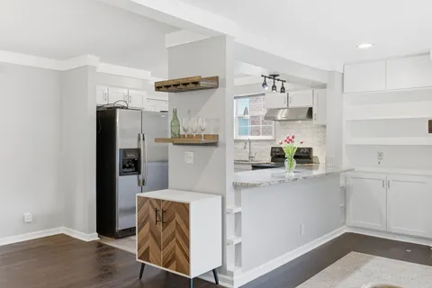 a kitchen with stainless steel appliances granite countertop a refrigerator and a sink