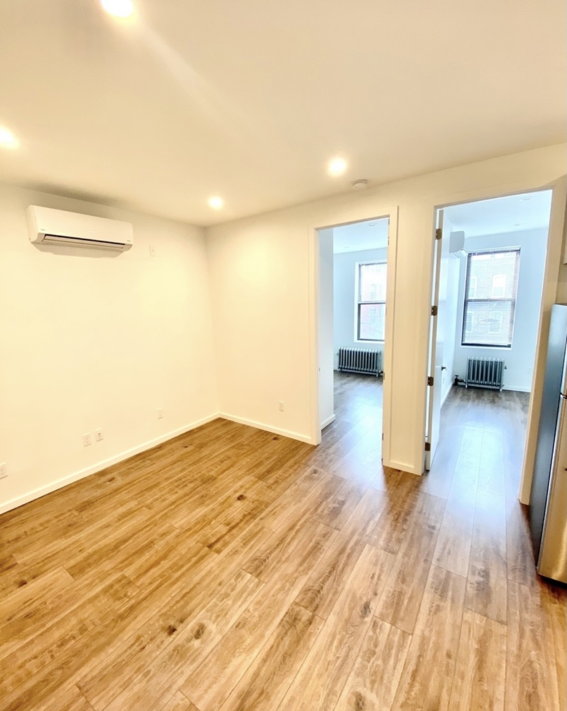 31-14 36th Street, Unit 3F Queens, NY 11106 - Photo 6 of 11 a view of empty room with wooden floor