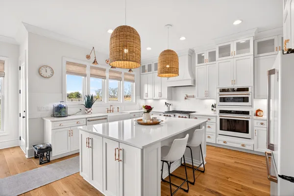 a bathroom with a granite countertop sink and a toilet
