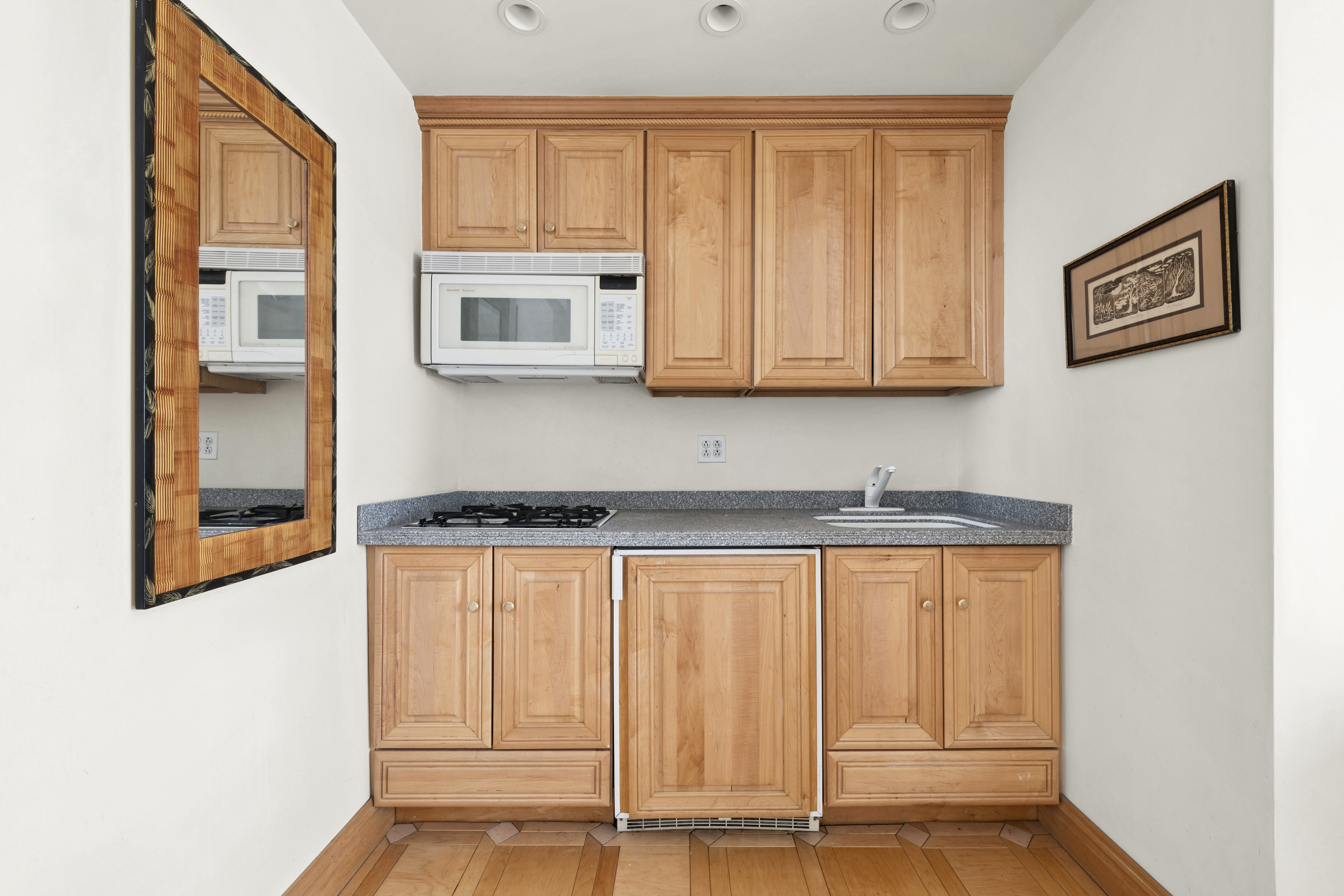 225 Central Park West, Unit 916 Manhattan, NY 10024 - Photo 5 of 13 a kitchen with stainless steel appliances granite countertop a stove a sink and white cabinets