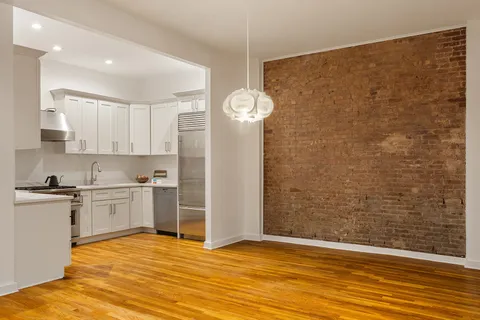 a view of a kitchen with a sink cabinets and wooden floor