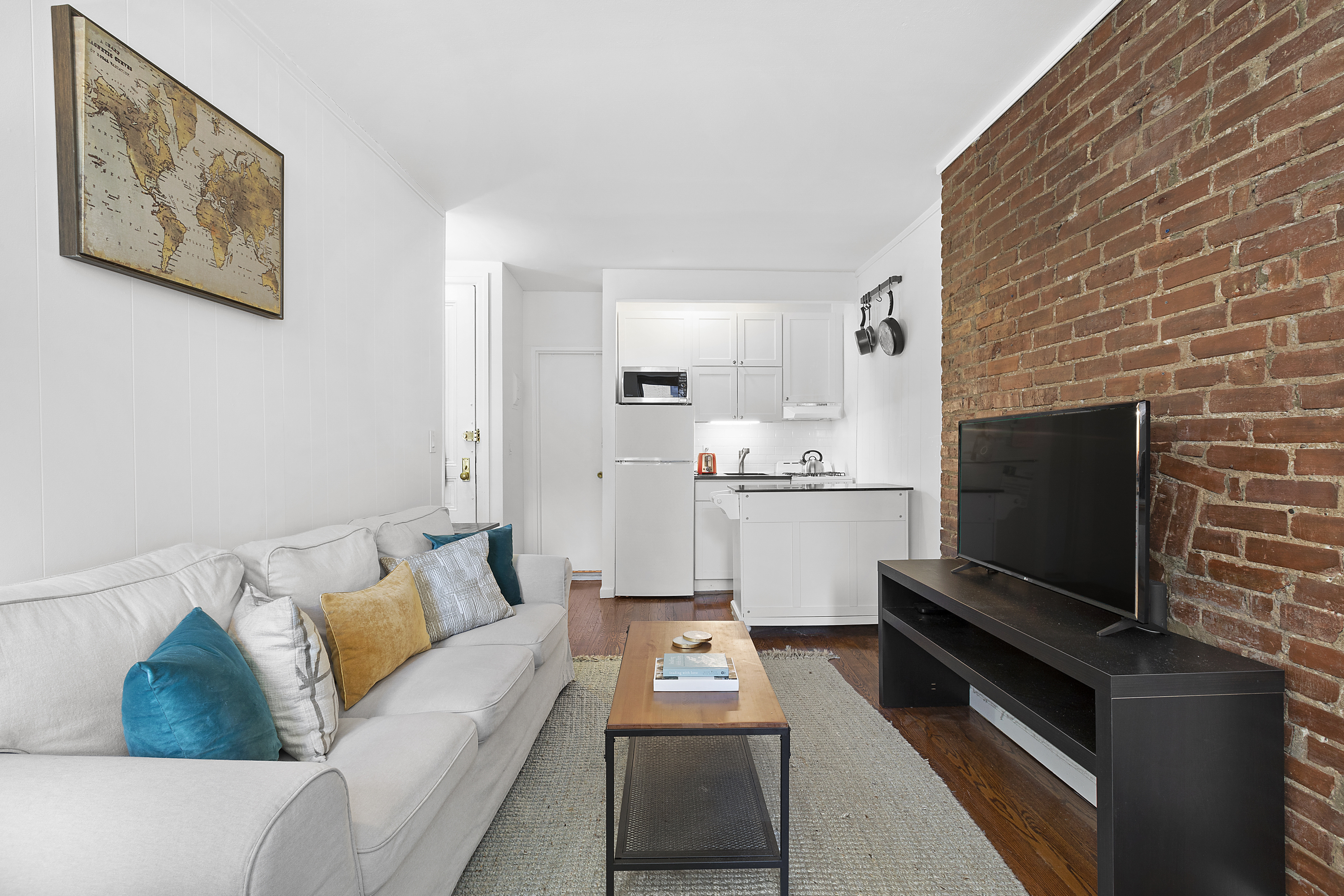 155 West 95th Street, Unit 6 Manhattan, NY 10025 - Photo 2 of 7 a living room with furniture and a flat screen tv
