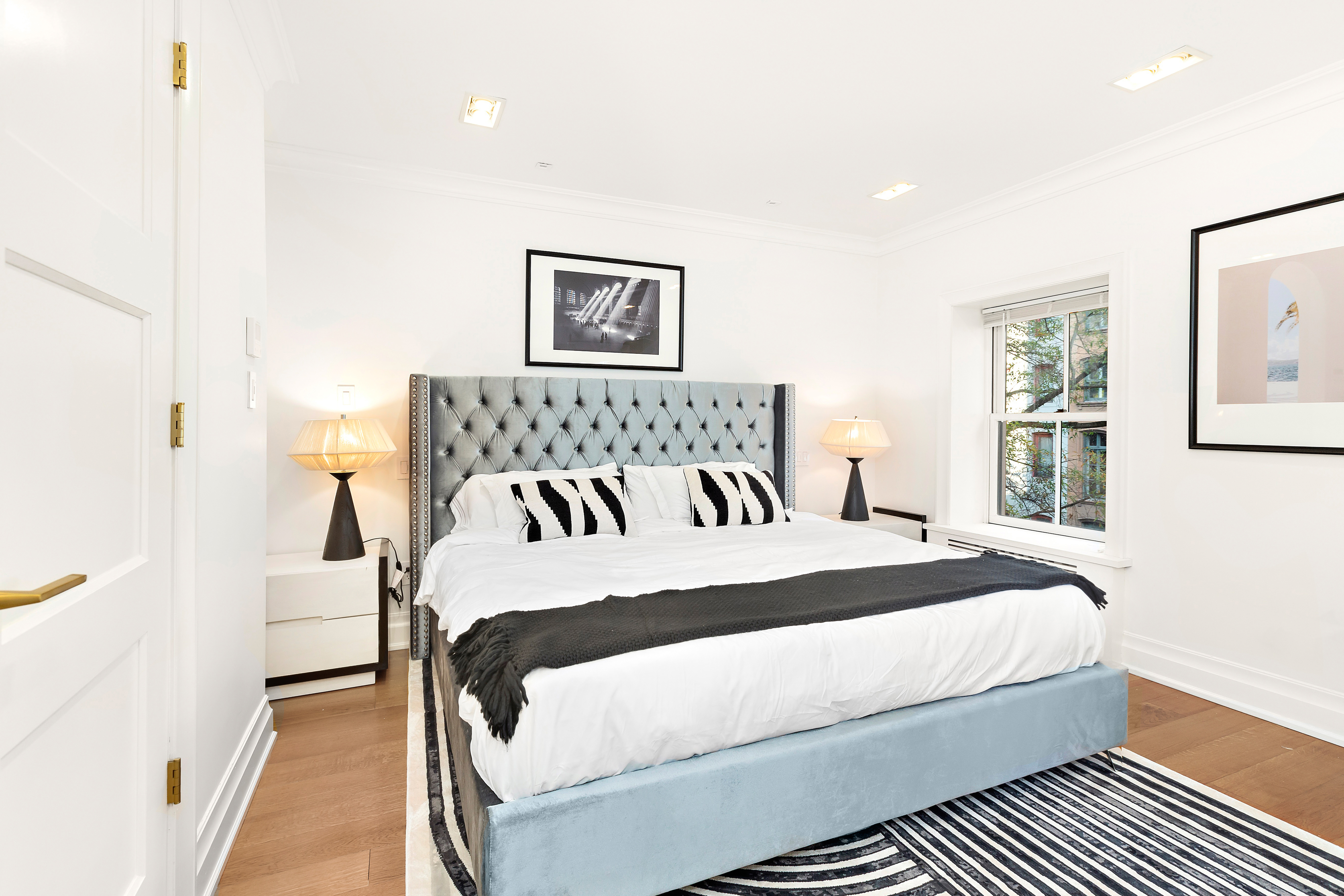 134 East 36th Street Manhattan, NY 10016 - Photo 11 of 28 a bedroom with a bed and a night stand