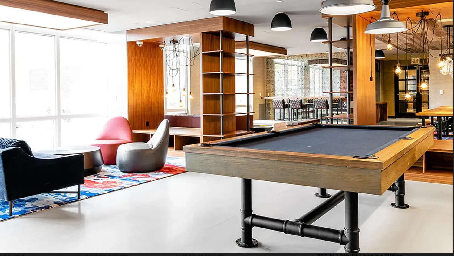 a room with furniture pool table and windows