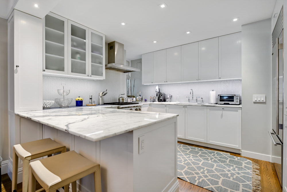 7 East 85th Street, Unit 5AB Manhattan, NY 10028 - Photo 5 of 12 a kitchen with a sink stainless steel appliances and cabinets