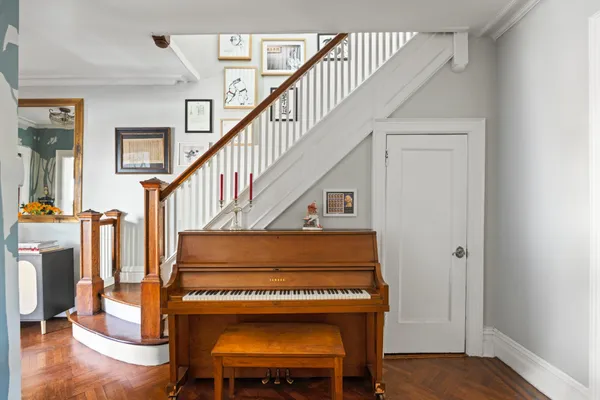 a view of entryway and hall with wooden floor