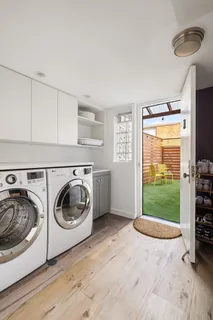 a utility room with sink dryer and washer