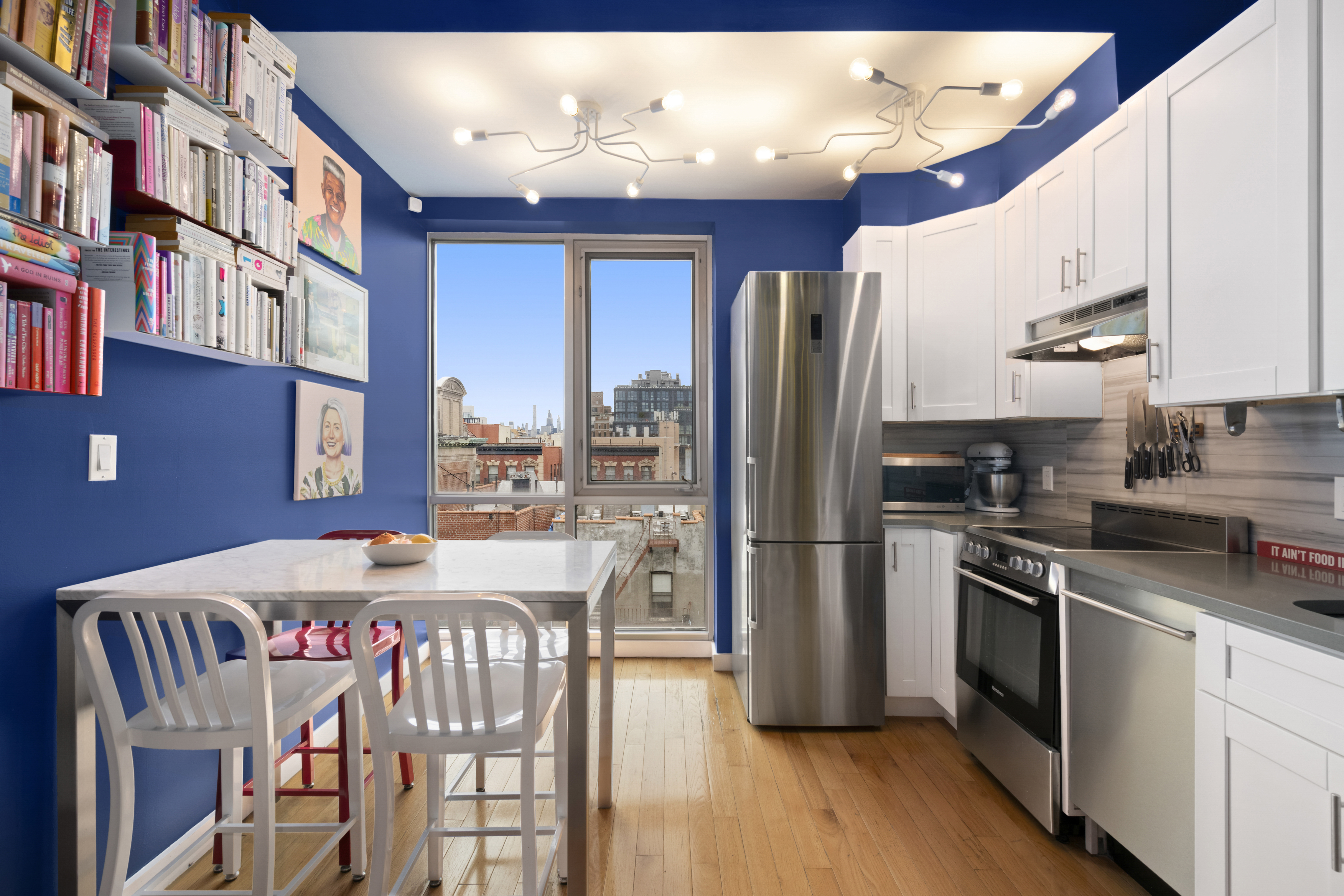 362 West 127th Street, Unit PHA Manhattan, NY 10027 - Photo 2 of 7 a kitchen with stainless steel appliances granite countertop a refrigerator a stove top oven a sink dishwasher and white cabinets with wooden floor