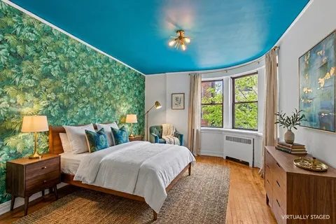 a bed room with a bed and a large window