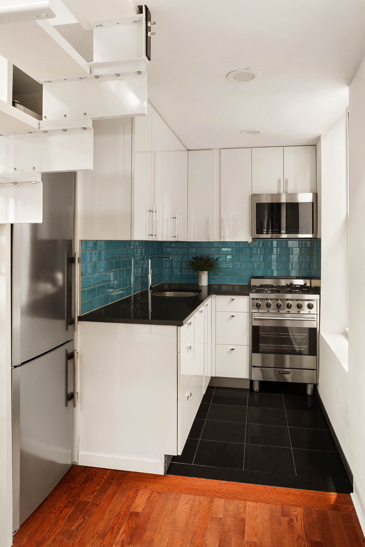 151 West 80th Street, Unit 5R Manhattan, NY 10024 - Photo 4 of 10 a kitchen with a refrigerator and a stove