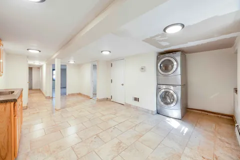 a view of a storage & utility room with a washer dryer