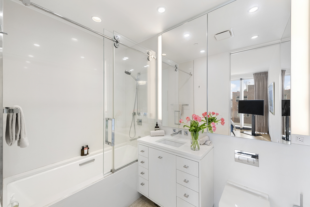551 West 21st Street, Unit 4D Manhattan, NY 10011 - Photo 10 of 16 a bathroom with a double vanity sink mirror and shower