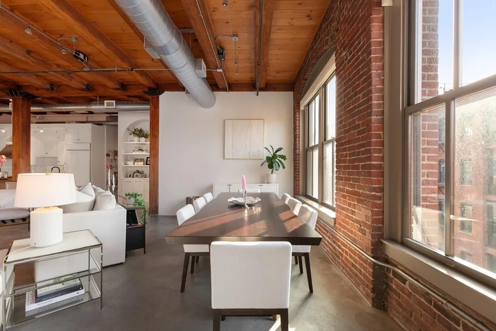 a dining room with furniture a chandelier and wooden floor