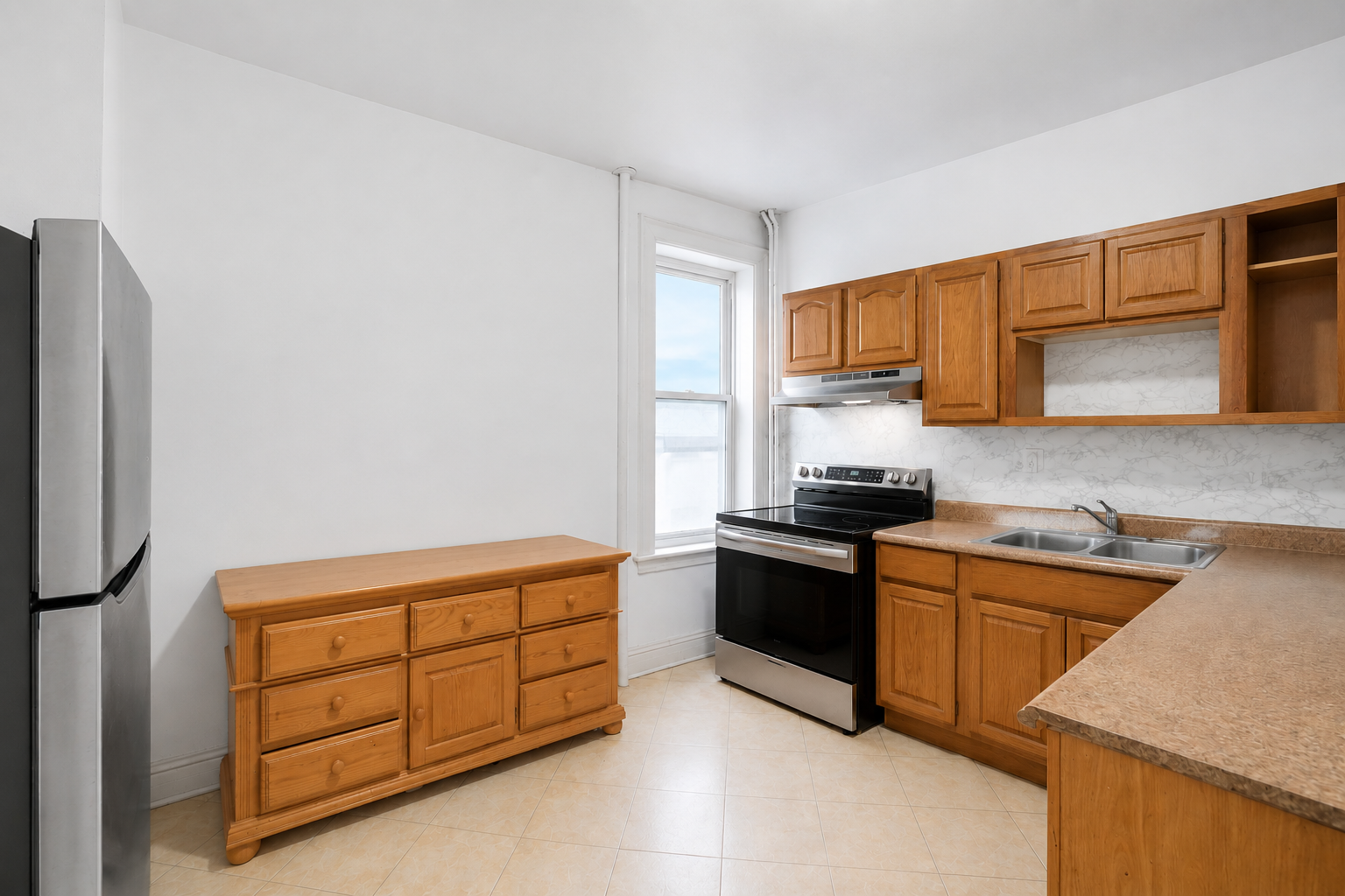 555 80th Street Brooklyn, NY 11209 - Photo 5 of 8 a kitchen with stainless steel appliances granite countertop a stove a sink and a refrigerator