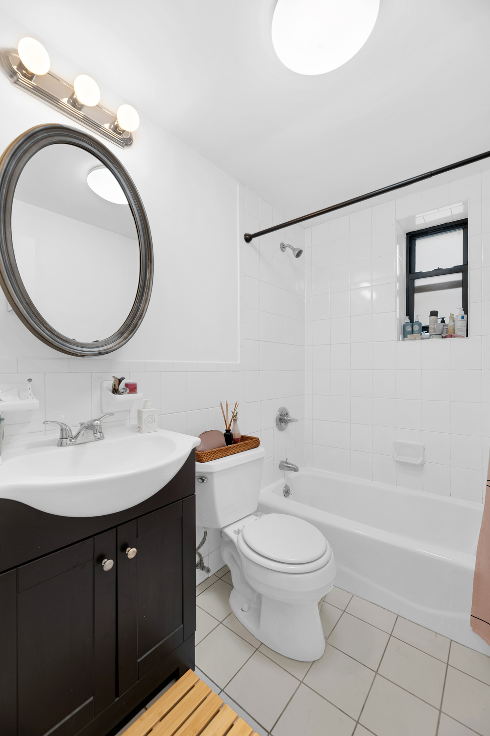 571 8th Street Brooklyn, NY 11215 - Photo 10 of 13 a bathroom with a sink a toilet and a mirror