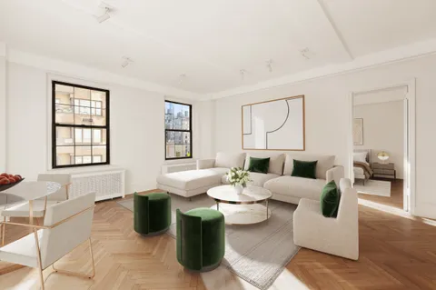 a living room with furniture a rug and wall painting