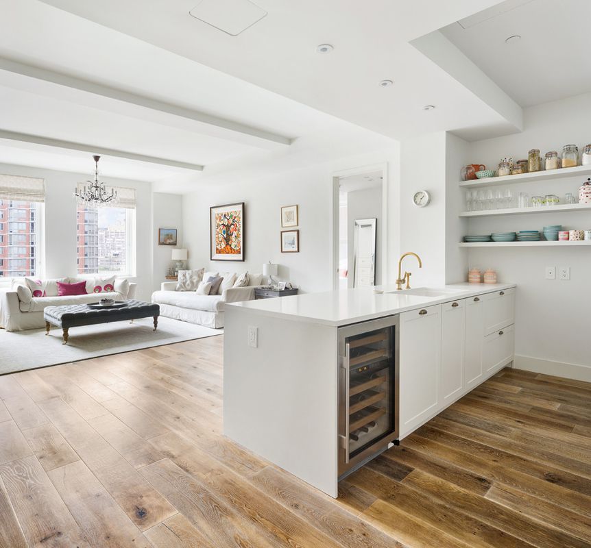 93 Worth Street, Unit 1401 Manhattan, NY 10013 - Photo 2 of 9 a view of living room kitchen with stainless steel appliances cabinets and wooden floor