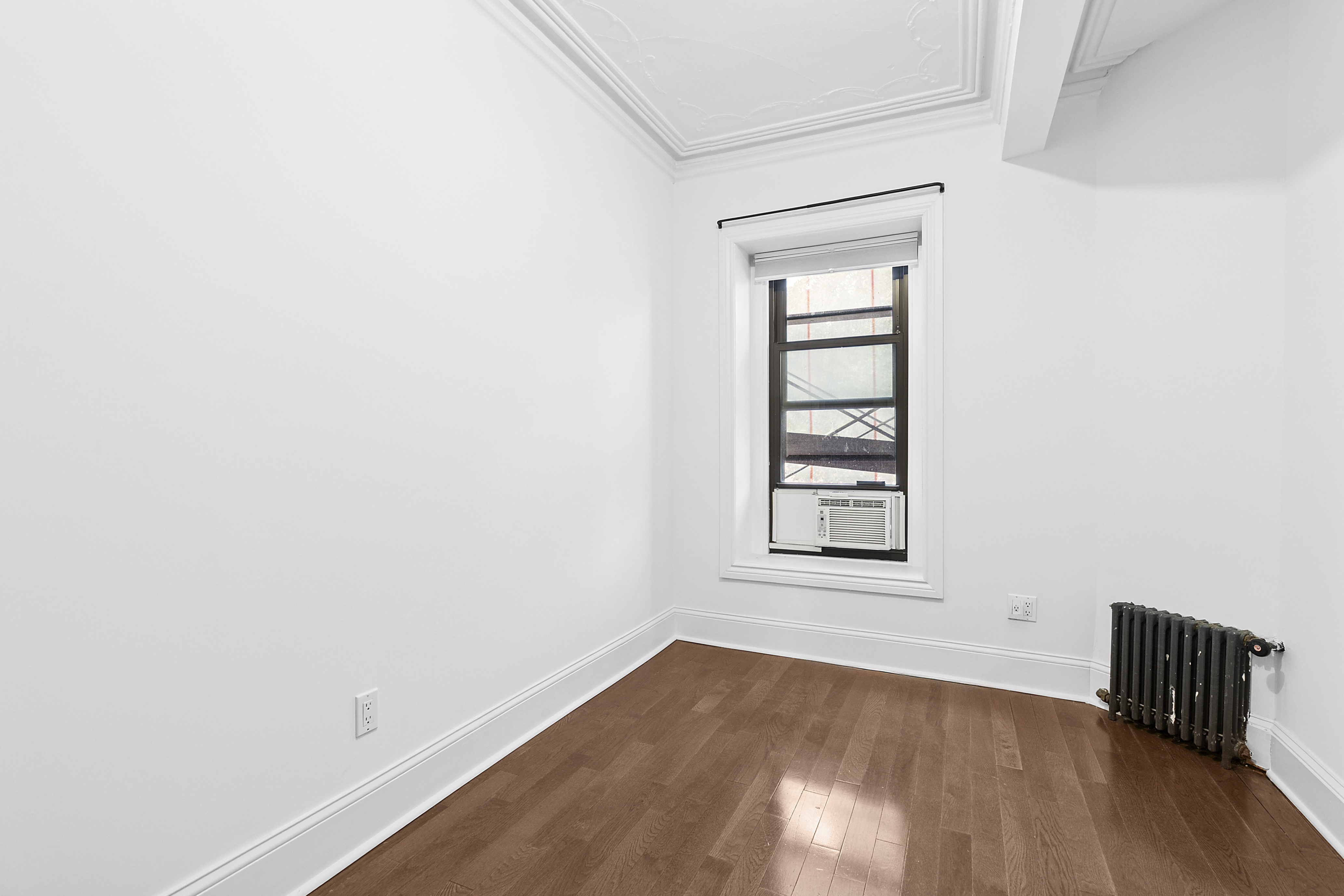 68 Downing Street, Unit 2 Brooklyn, NY 11238 - Photo 6 of 8 an empty room with wooden floor and windows