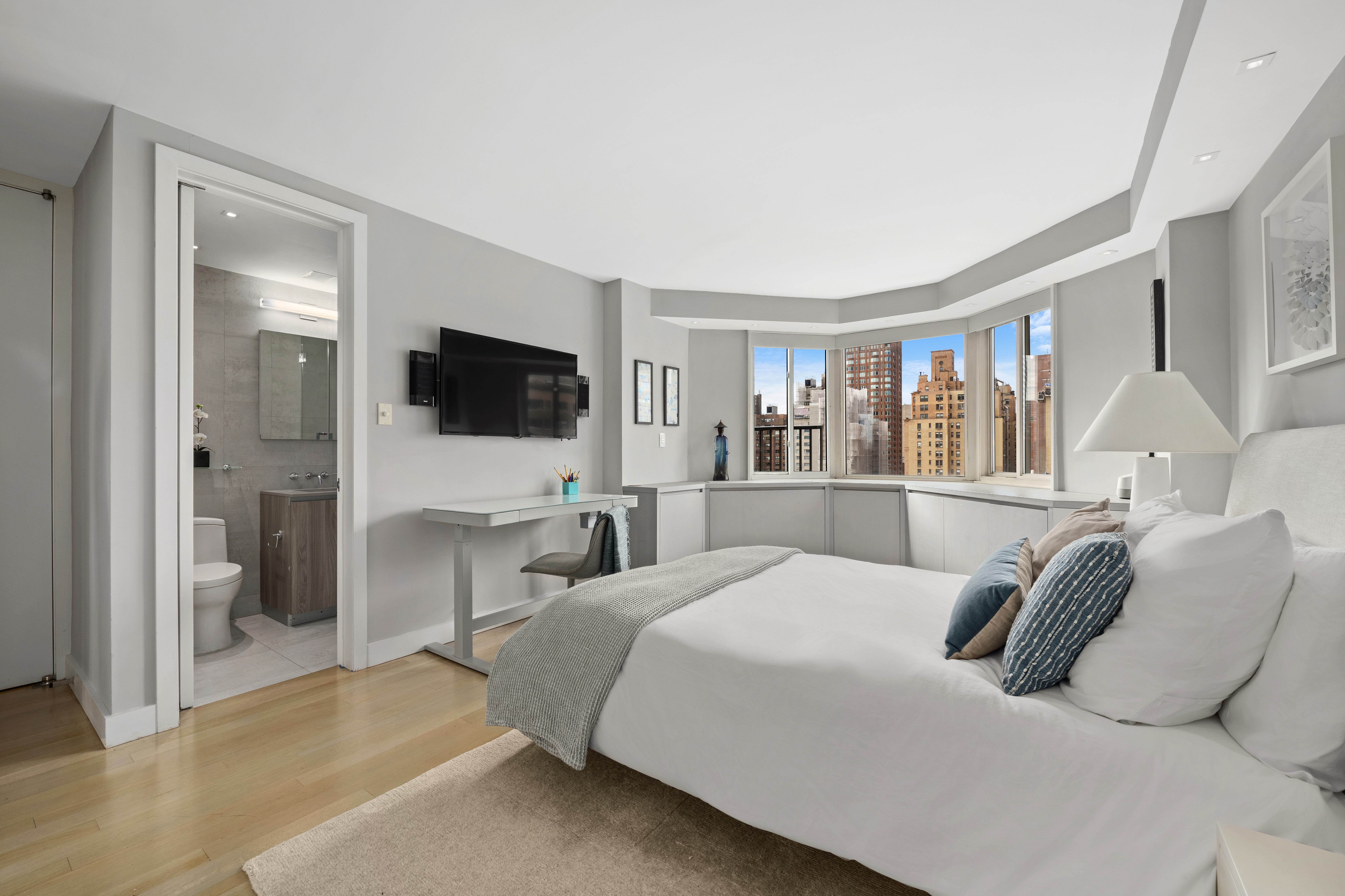 a bedroom with a large bed and a flat screen tv