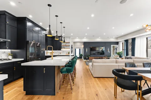 a large kitchen with a table and chairs