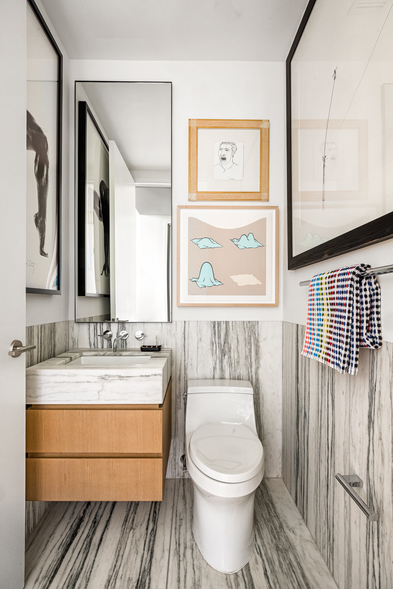 33 Park Row, Unit 6B Manhattan, NY 10038 - Photo 17 of 24 a bathroom with a granite countertop toilet sink and mirror