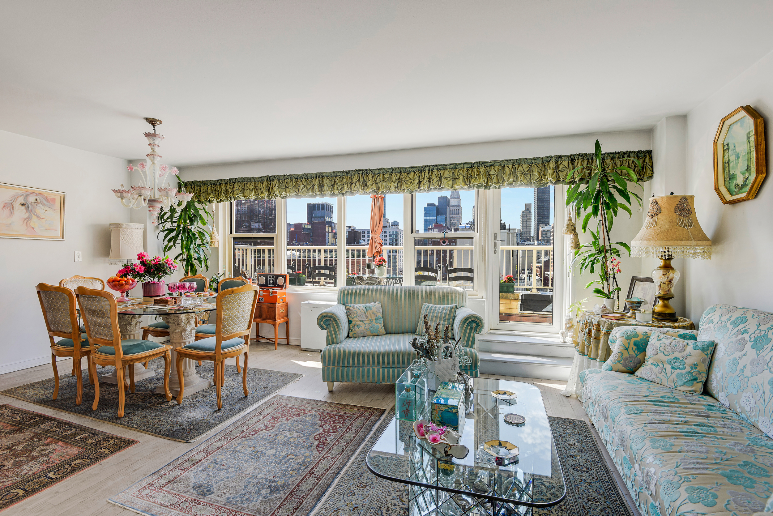 305 East 24th Street, Unit 18C Manhattan, NY 10010 - Photo 1 of 13 a living room with furniture and a large window
