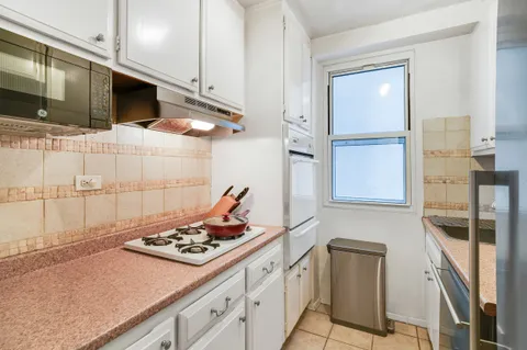 a kitchen with stainless steel appliances a stove a sink and a refrigerator