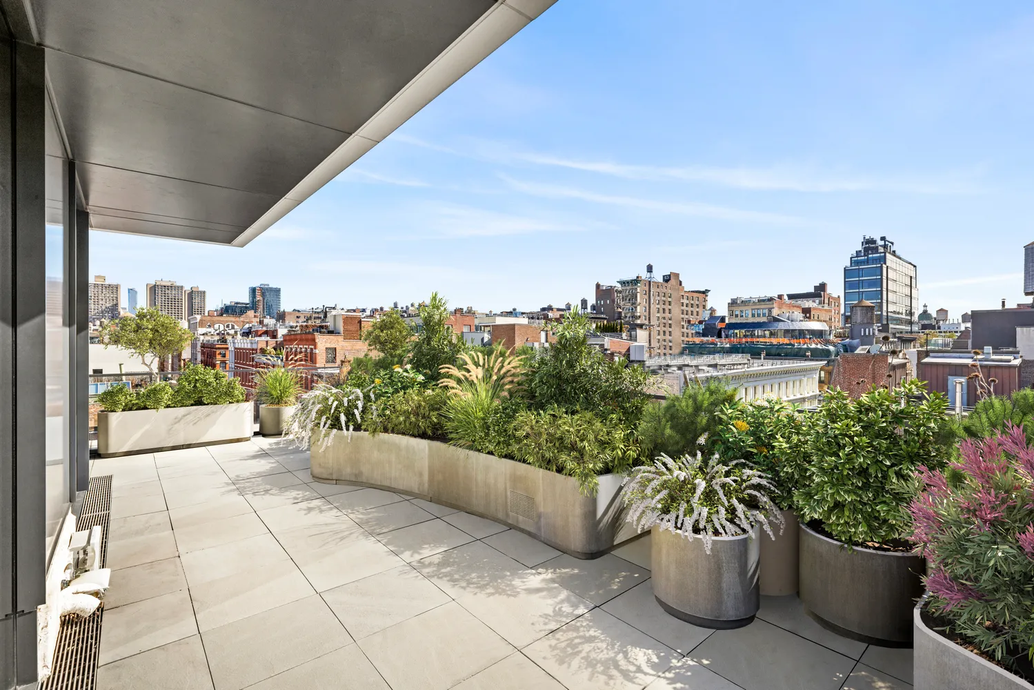 a view of a terrace with chairs and potted plants