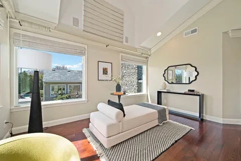 a bathroom with a granite countertop toilet sink and mirror