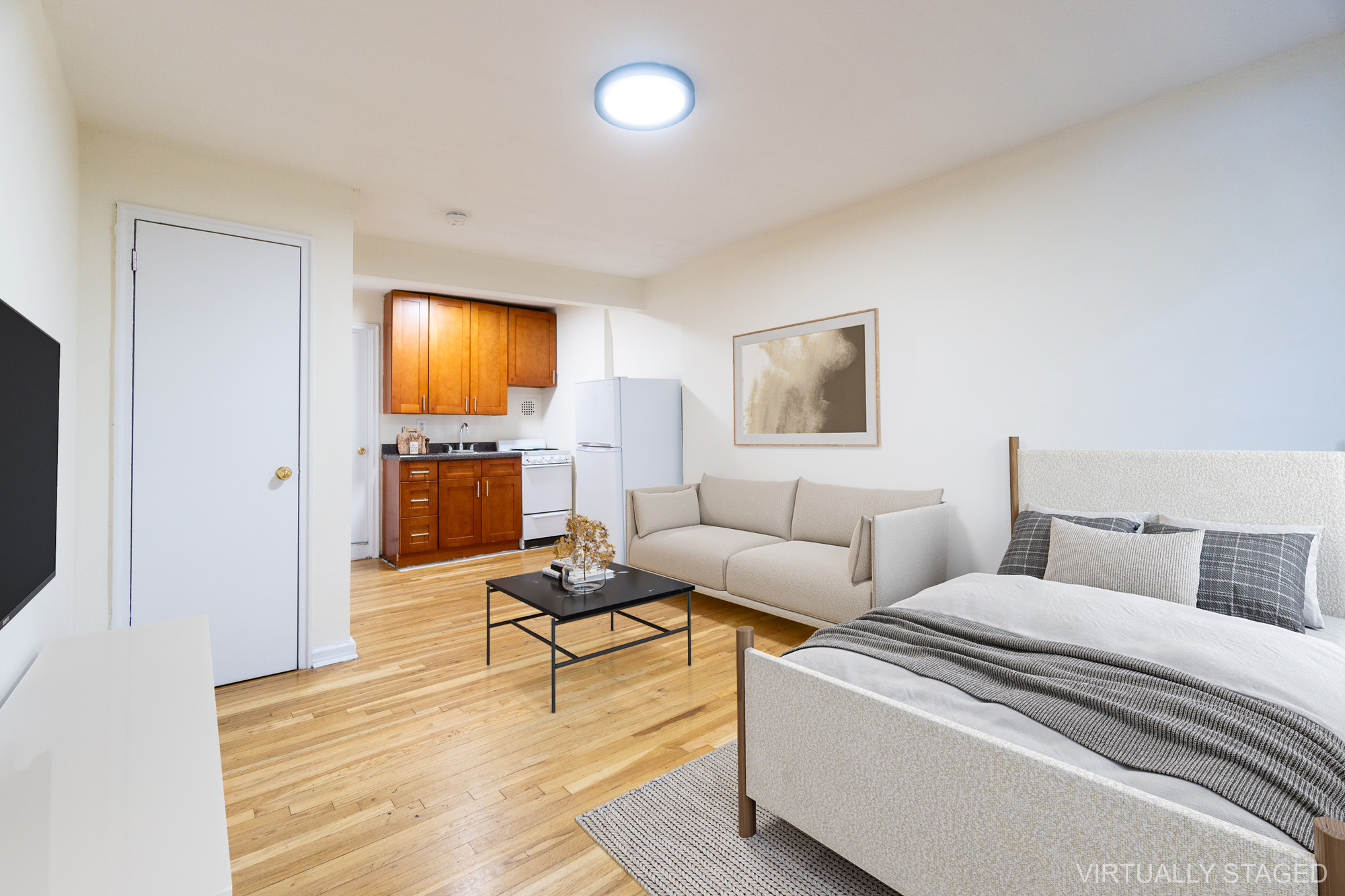 319 East 5th Street, Unit B Manhattan, NY 10003 - Photo 8 of 17 a living room with furniture and a flat screen tv