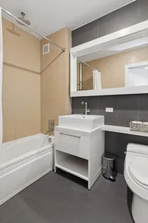 a bathroom with a sink a toilet and bathtub