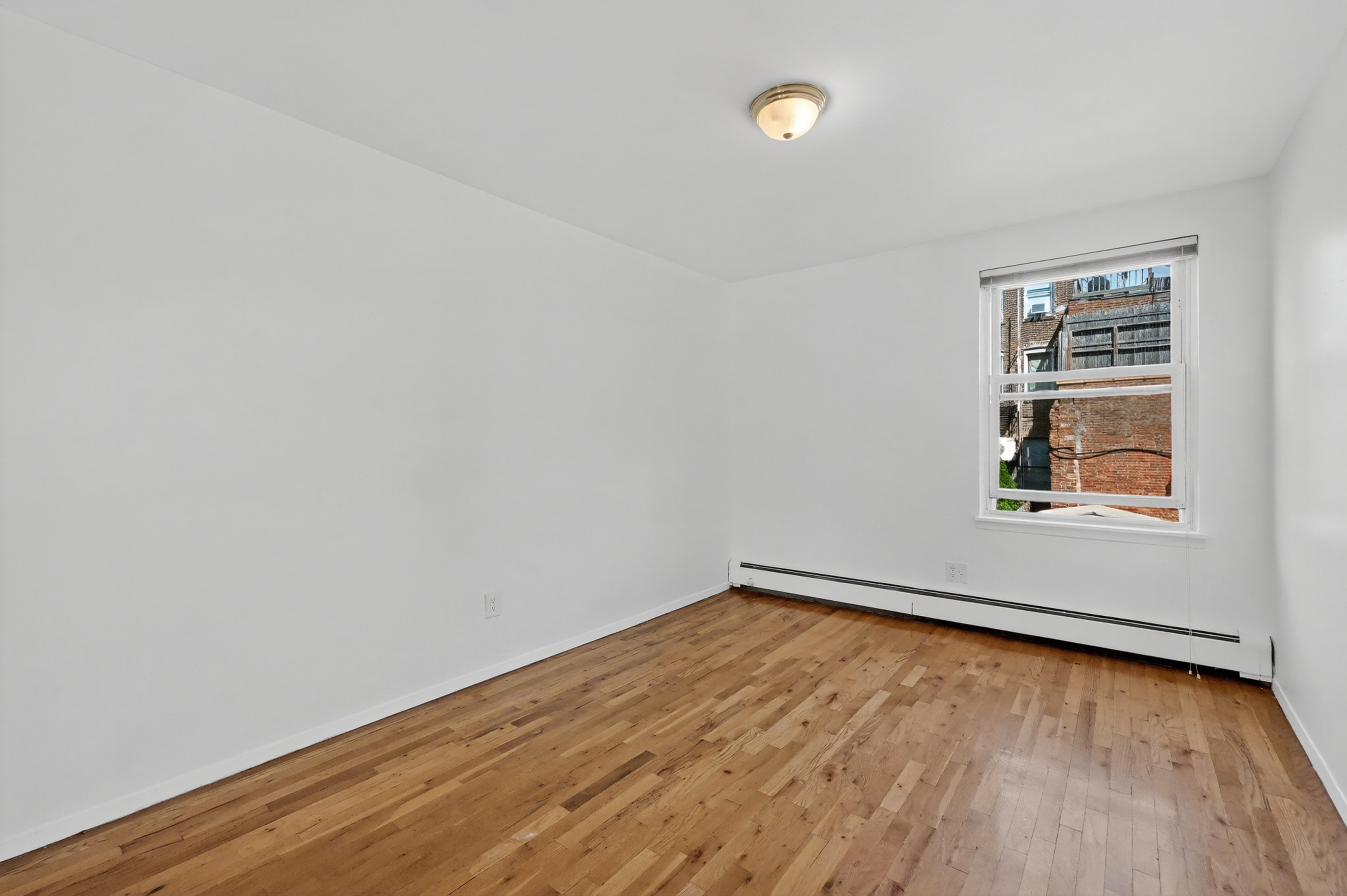 81 President Street, Unit 51-A Brooklyn, NY 11231 - Photo 21 of 27 an empty room with wooden floor and windows