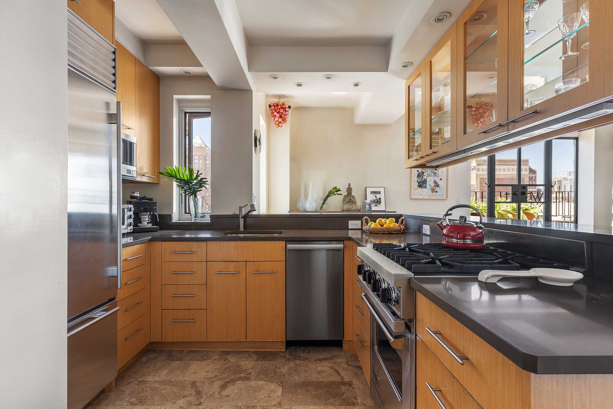 200 East 16th Street, Unit 19D Manhattan, NY 10003 - Photo 7 of 14 a kitchen with stainless steel appliances granite countertop a sink stove and refrigerator