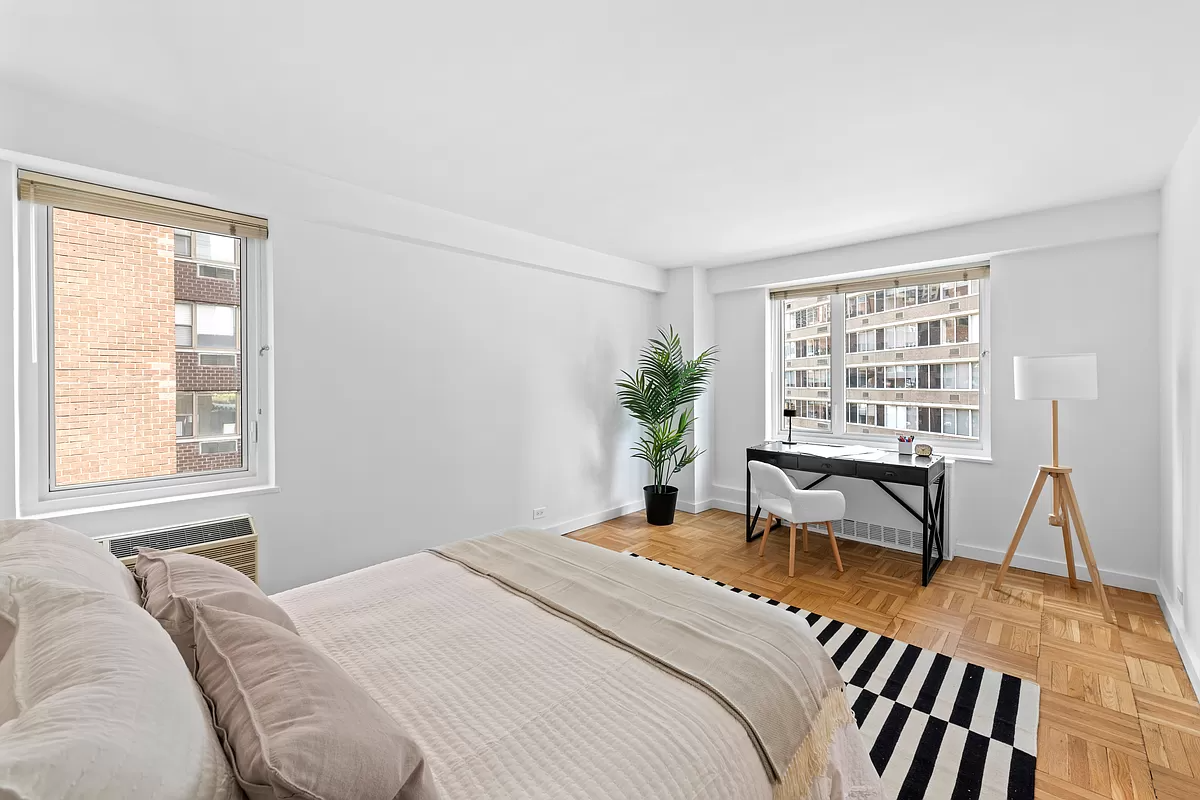 411 East 53rd Street, Unit 17A Manhattan, NY 10022 - Photo 6 of 10 a bedroom with a bed and a table