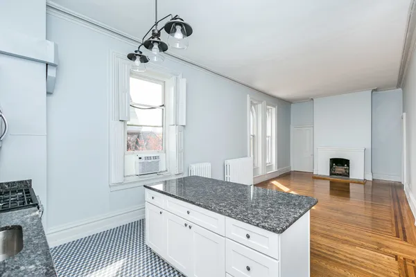a spacious bathroom with a granite countertop sink a mirror and shower