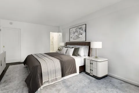 a bedroom with a bed and lamp