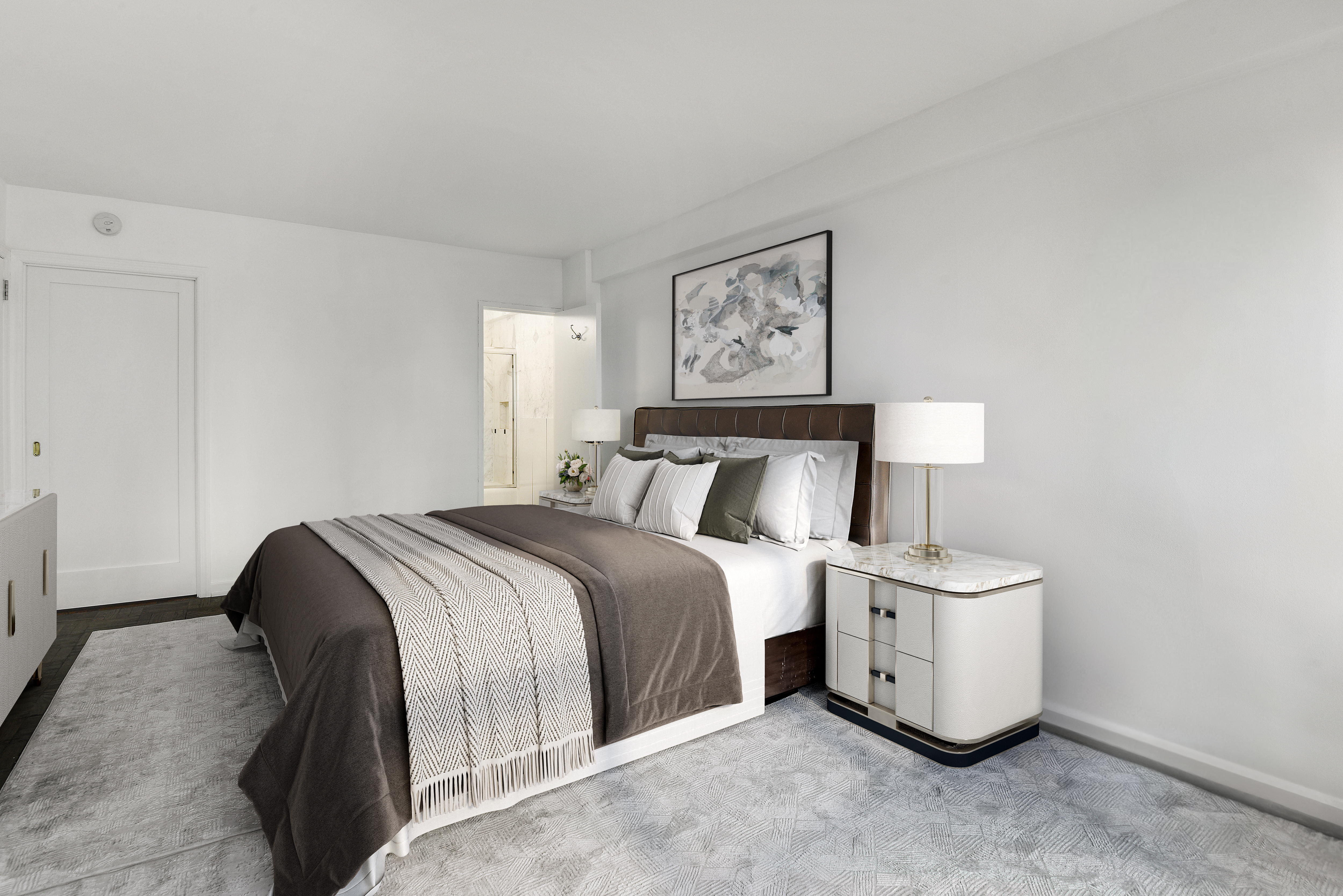 150 East 61st Street, Unit 5C Manhattan, NY 10065 - Photo 12 of 18 a bedroom with a bed and lamp